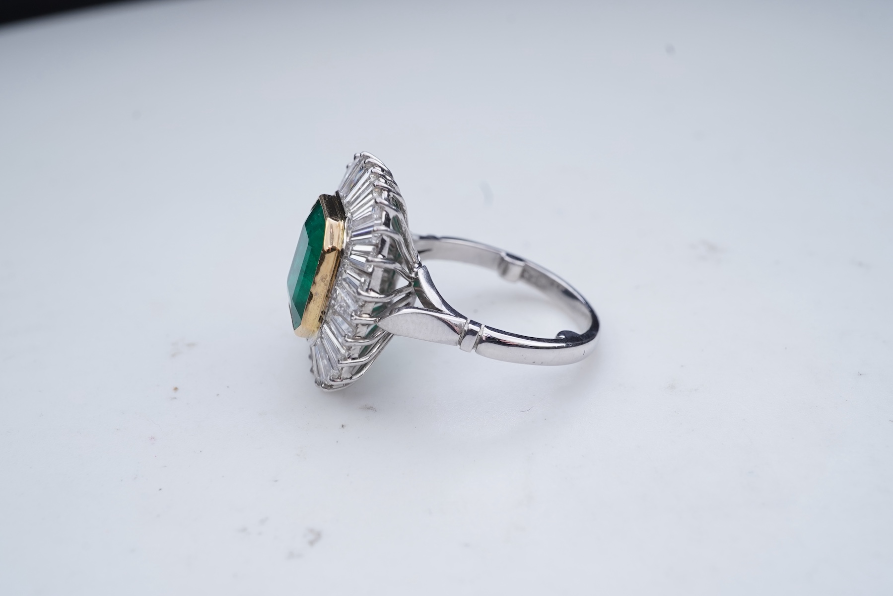 An emerald and diamond ring